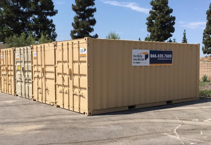 portable storage shipping container in the air on a forklift