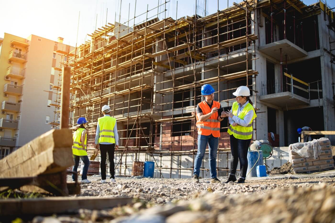 Construction workers in front of building with scaffolding