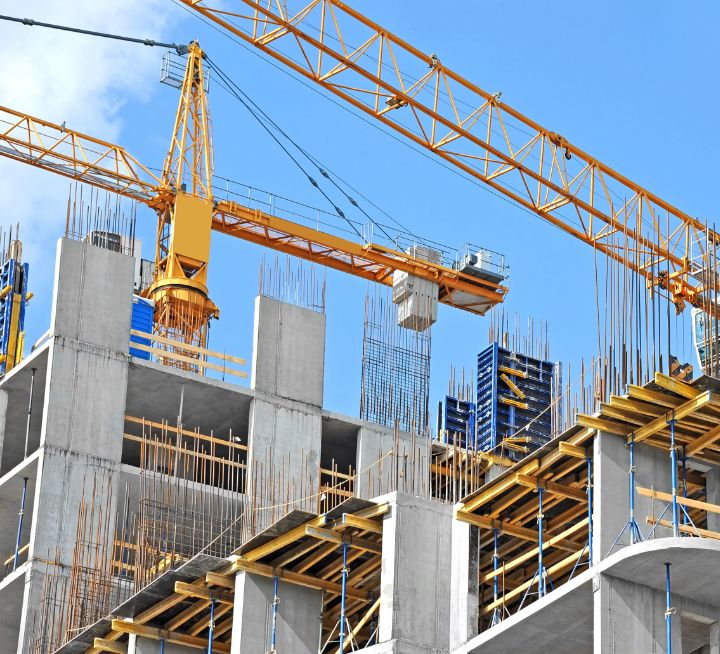 Building under construction with scaffolding and cranes