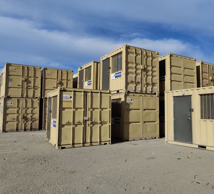 stacked portable storage shipping containers in a yard